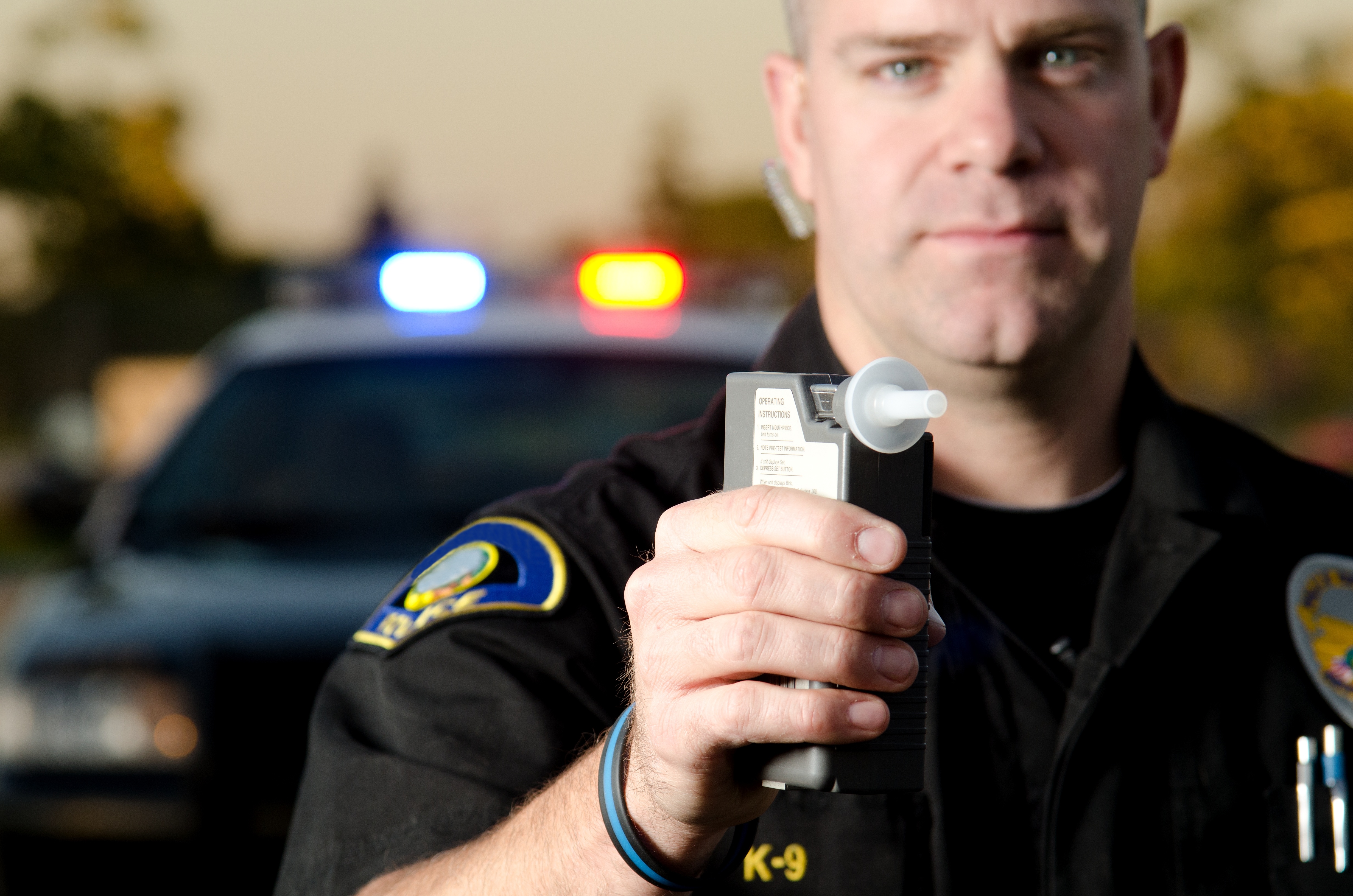 A police officer pulling someone over for a holiday DUI charge - if you fnd yourself in this situation, call Branson West Law today for an expert DWI attorney in Utah.