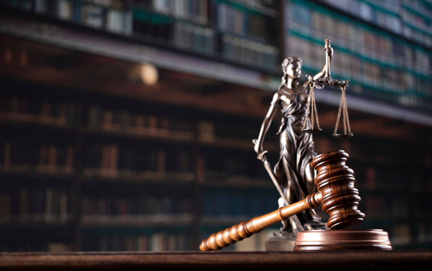 A picture of a Lady Lustice statue on a desk - for an aggressive criminal defense attorney in Utah, call Branson West Law.
