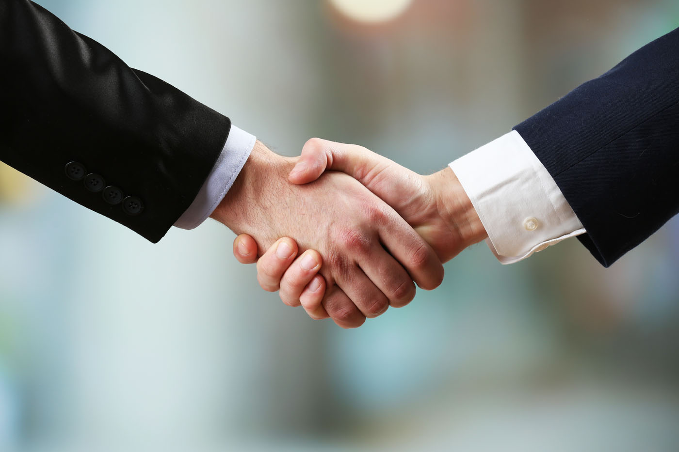 Two people shaking hands, read our client testimonials in Utah.
