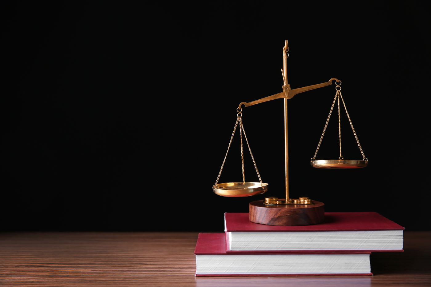 An image of books and a scale - hire Brason, a Utah retail theft lawyer, to defend you in court.