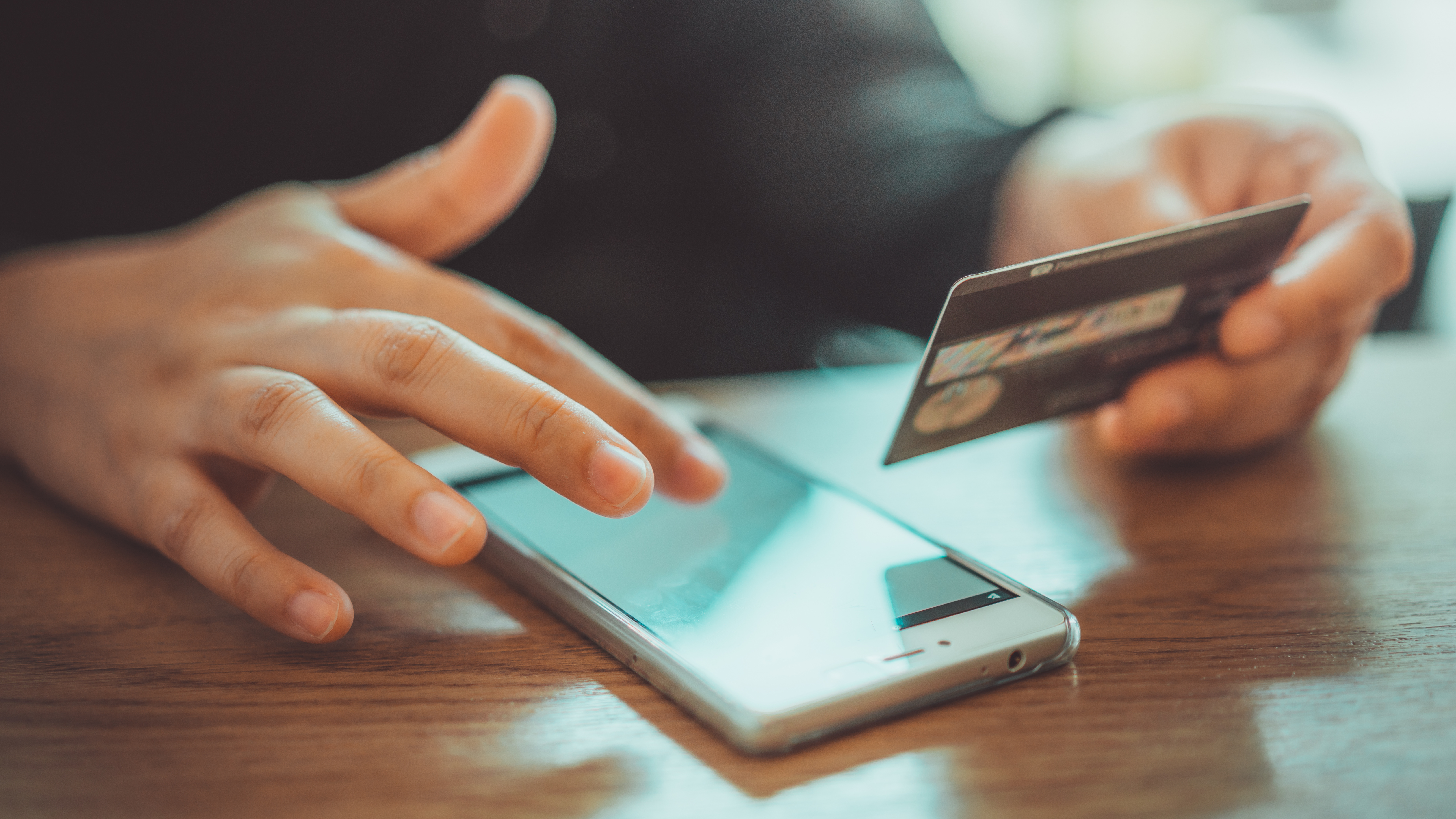 A person struggling with a debit card fraud charge - contact Branson West Law today for a Utah debit card fraud lawyer.