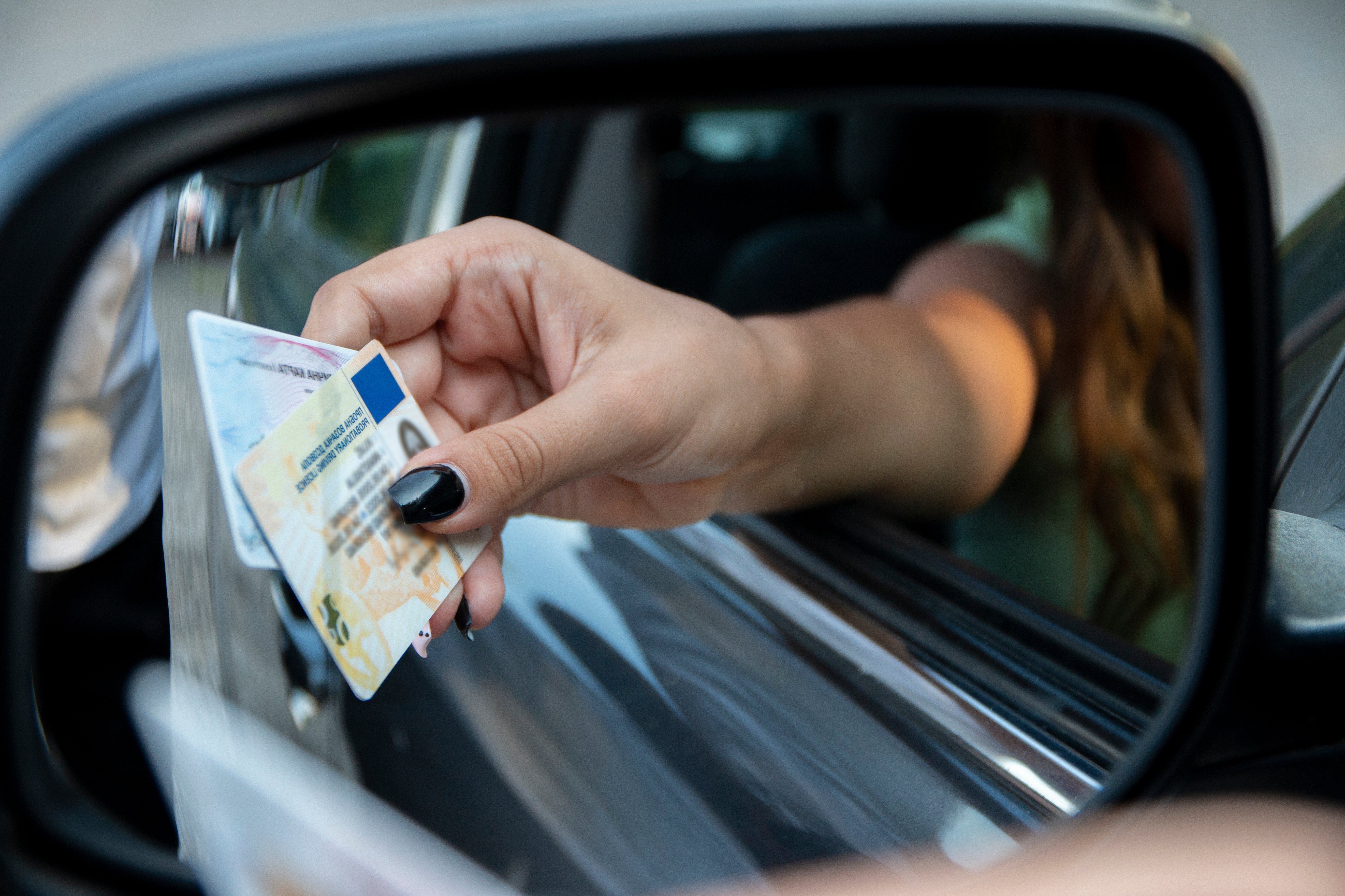A driver presenting a license during a traffic stop - choose Branson West Law for your violating an alcohol restricted license defense attorney in Utah.