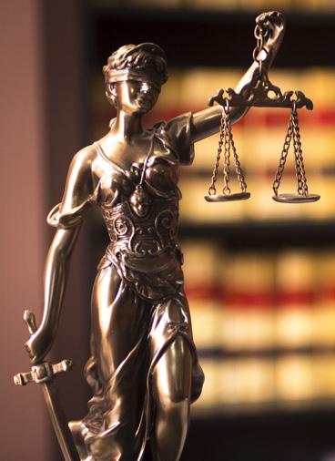 A statue of a blindfolded woman holding a scale represents justice - contact Branson West Law today for help with your case.