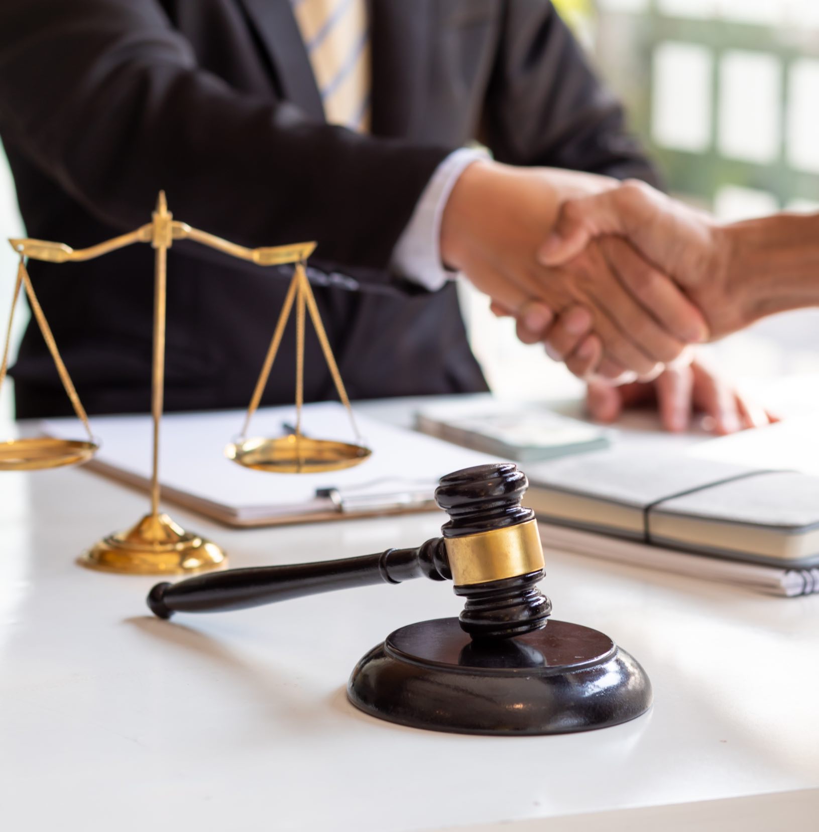 A lawyer and client shake hands - contact Branson West Law today for help with your case!